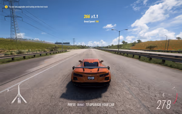 Orange sports car speeding on a highway test track under a bright blue sky.