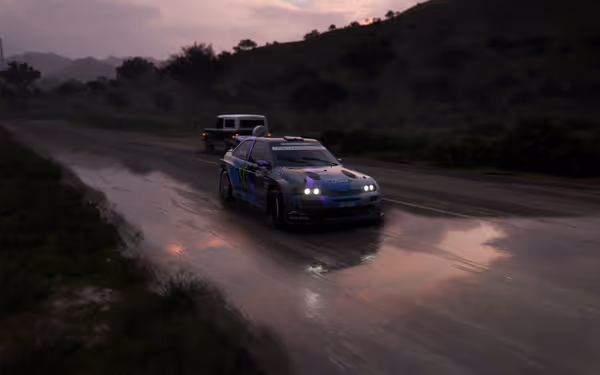 At sunset, a rally car races down a wet road, its headlights flashing brightly.