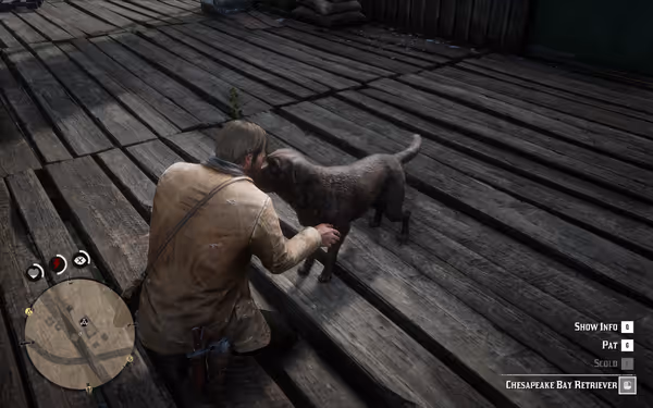 A man kneeling to interact with a dark-coated dog on a wooden platform.
