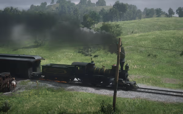 A steam train chugs through the countryside, leaving a trail of smoke behind.