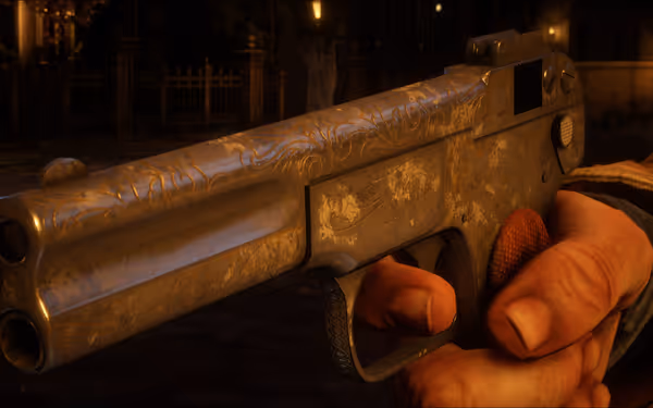 Hand holding engraved pistol in dimly lit outdoor setting.