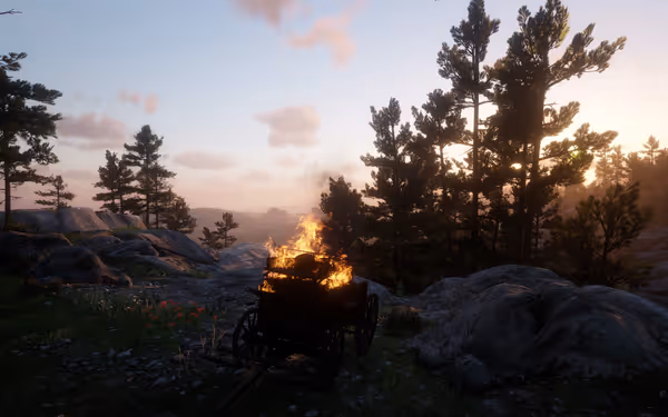 Burning cart on rocky hill with trees, sunset sky.