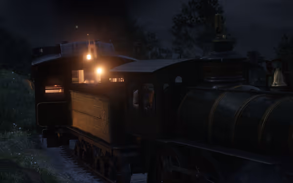 Steam engine pulls train cars along dark tracks.
