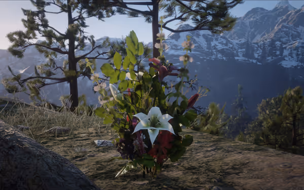 Flowers on a rocky ground with trees and snowy mountains in the background.