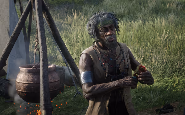 Person holding flowers near a cooking pot over a fire.