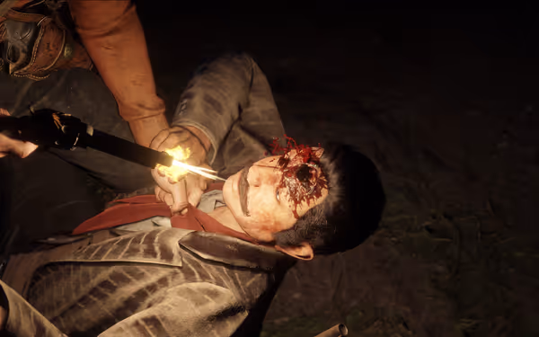 A man lies on the ground, injured, as another points a flaming weapon.