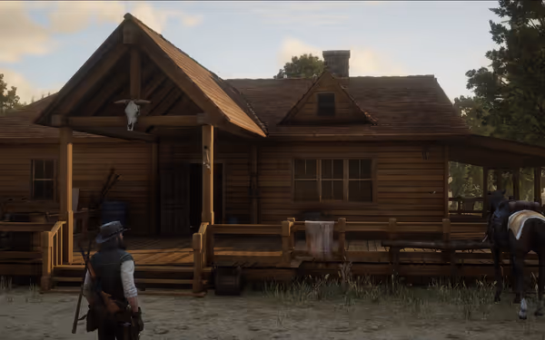 A man and a horse are standing in front of a wooden cabin with a porch.