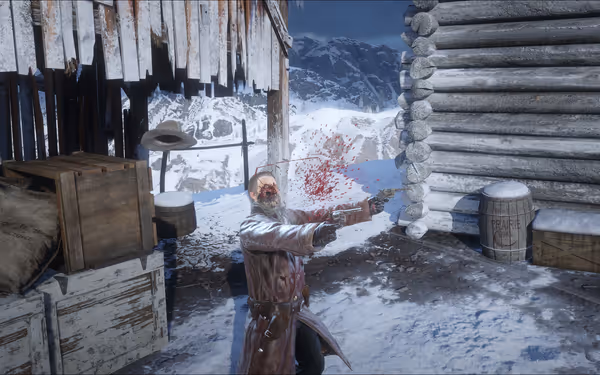 A man in a snowy area is shot, blood spraying, holding a revolver.