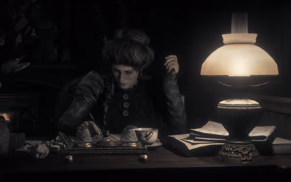 A woman with braided hair sits at a table under a glowing lamp.