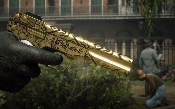 A gloved hand holds an ornate golden pistol with engraved patterns outdoors.