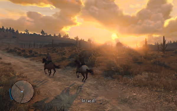 Two riders on horseback travel a dusty trail at sunset with cacti nearby.