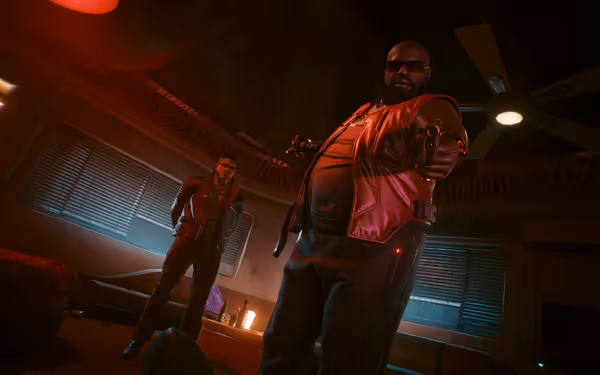 A large man in sunglasses aims a gun, while another stands behind watching