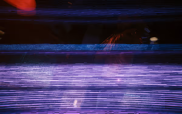 A heavily distorted image with blue and purple digital glitches obscuring the background