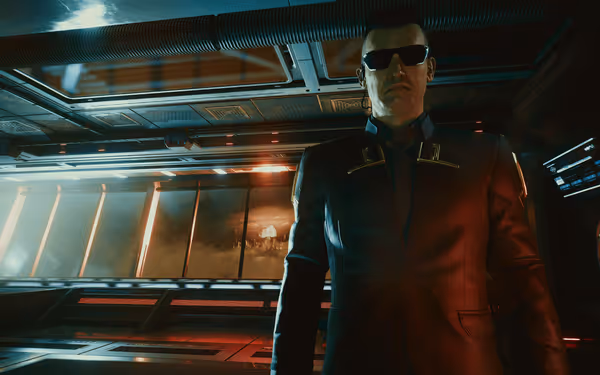A stern man in a futuristic suit and sunglasses stands before a distant explosion