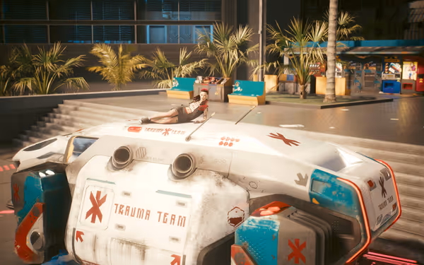 A wounded woman lies on top of a futuristic Trauma Team ambulance near stairs.