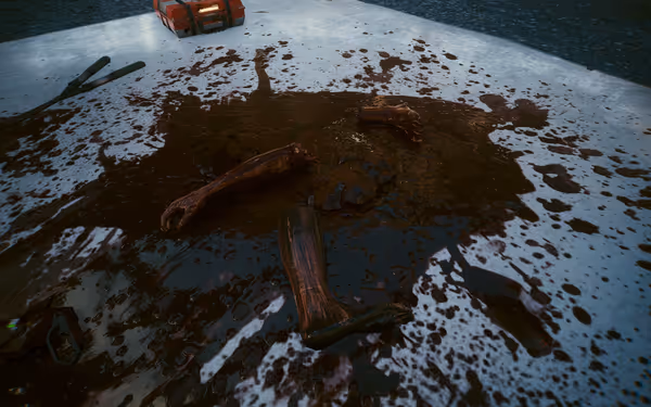 Severed limbs covered in blood on a metallic surface with tools and a case.