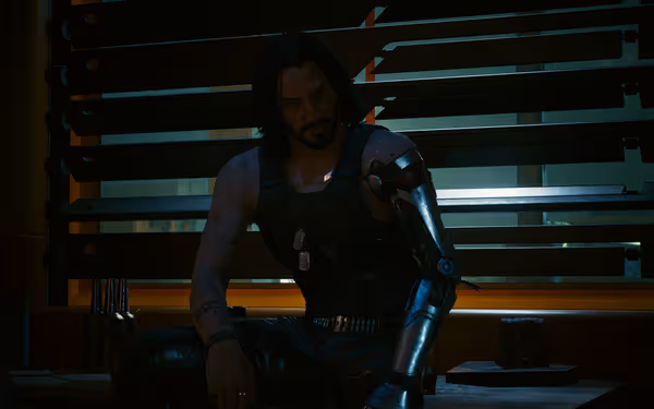 Man with cybernetic arm and dog tags sits in shadowed room near shuttered window.