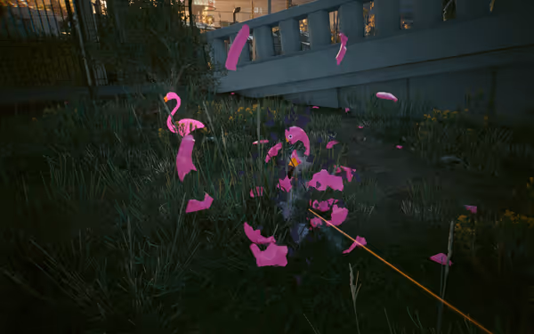 A bright pink plastic flamingo shatters mid-air from a gunshot in grassy terrain.