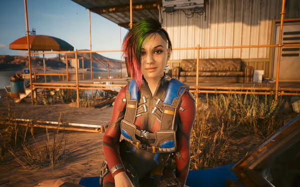 Female character with green and pink hair sits outside near a rusty scaffold.