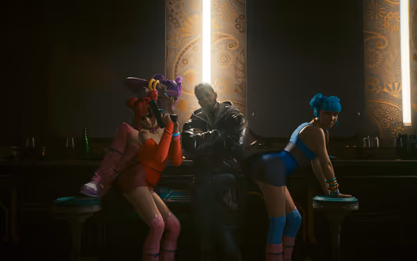 Man in black jacket poses with three women in bright outfits.