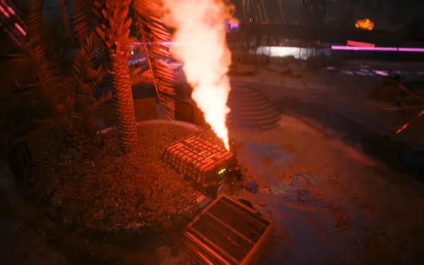 A smoking supply crate emits red light near a palm tree in a deserted area.