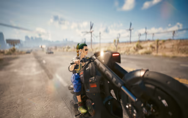 Person with green braided hair does a wheelie on a black futuristic motorcycle on a desert highway.