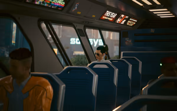 A woman with facial cybernetics and sunglasses sits alone on a futuristic train.