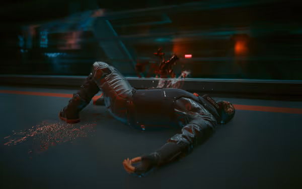 A man in futuristic armor lies dead on the floor with blood splattered behind him.