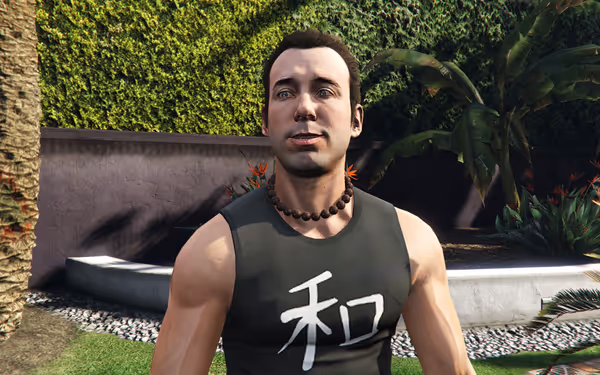 A smiling man with beaded necklace wears black sleeveless shirt with white kanji symbol.