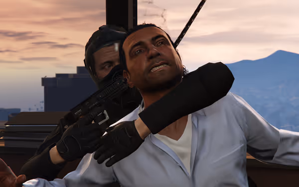 A gloved figure holds a pistol to a man's head in front of a window at sunset.