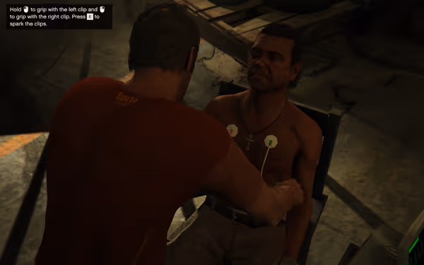 A shirtless man with clips on his chest sits as another person prepares to spark them.