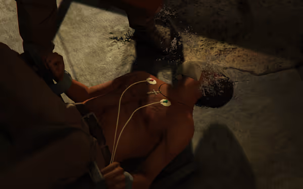 A shirtless man is tied down with wires on his chest while water is poured over his face.