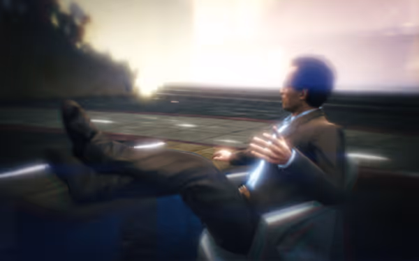 A man in a suit sits in a chair with his feet up, facing bright light.