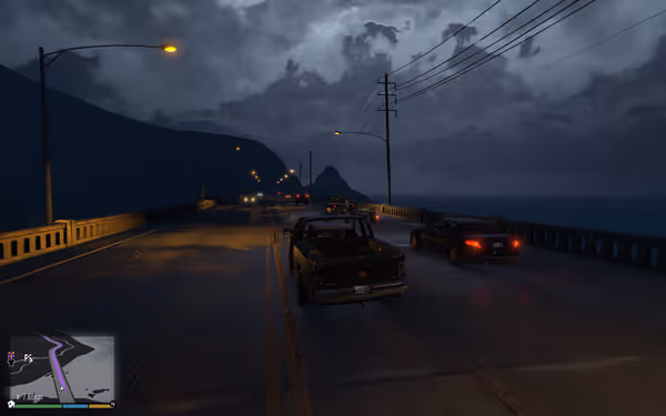 Pickup truck and black car driving on a rainy coastal bridge at night.