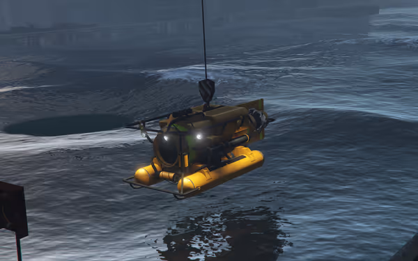 A small yellow submersible is suspended over the water by a crane at a port.