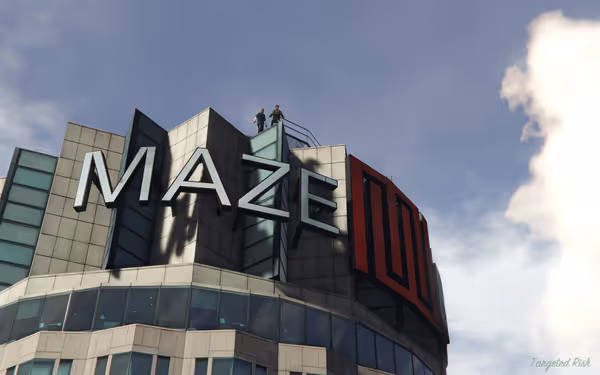 Two people stand on top of a building with a large "MAZE" sign.