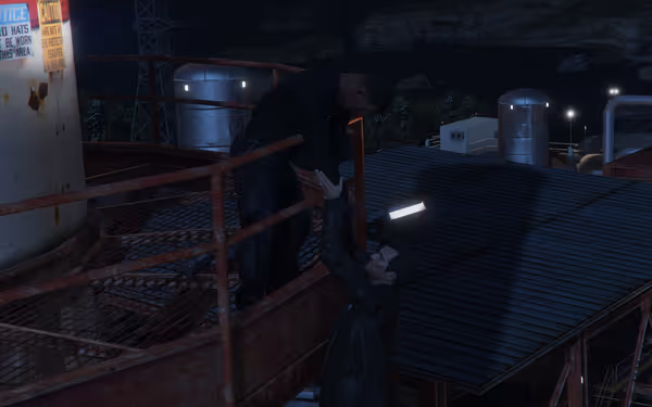 Two men are on a metal platform at night—one is reaching up while the other helps pull him up.