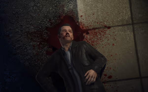 Man in dark jacket lies on ground with blood pooling behind his head.