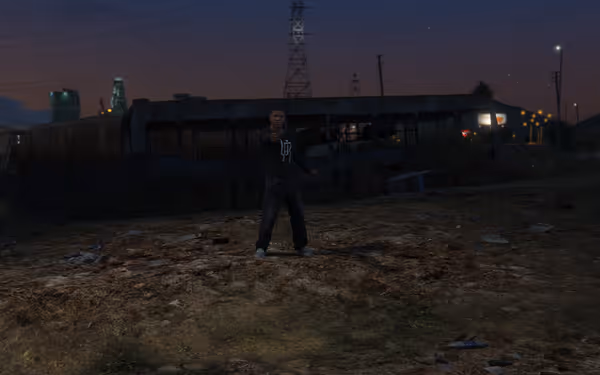 A man stands outside at dusk pointing a handgun, with an abandoned bus behind.