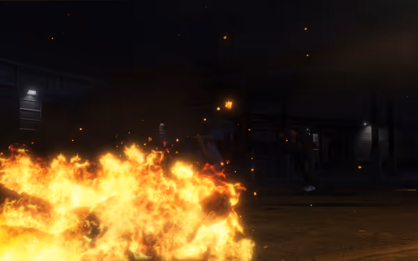 A person is crawling while engulfed in flames, with another person recoiling in the background.