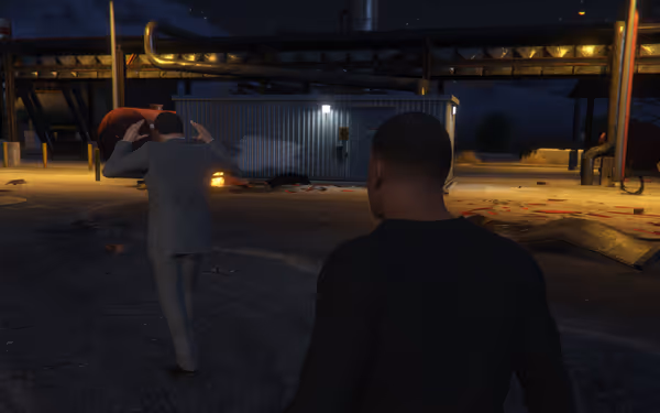 A man in a suit raises his arms as another man approaches outside at night.