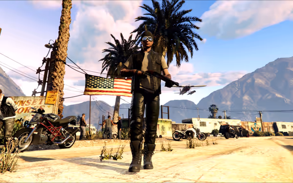 A person in dark clothes holds a shotgun, standing near motorcycles and an American flag.