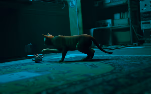 A cat is reaching out toward a small robot lying on a patterned rug.